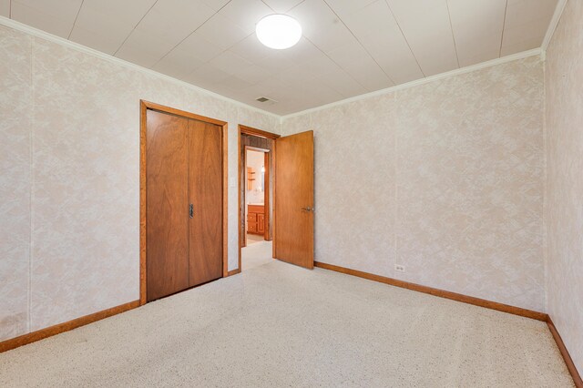 8607 Cochise Ct, Howard City, MI 49329 - unfurnished bedroom featuring ornamental molding, a closet, wallpapered walls, and baseboards