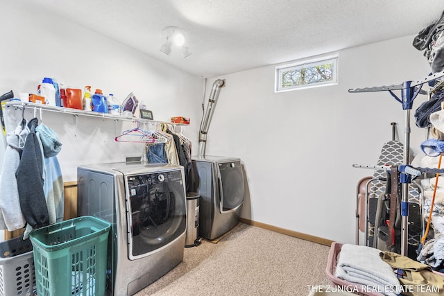 1087 Shore Walk Ln, Whitehall, MI 49461 - laundry room with washing machine and clothes dryer, carpet flooring, a textured ceiling, and baseboards
