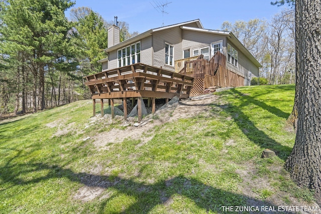 1087 Shore Walk Ln, Whitehall, MI 49461 - back of property featuring a deck, a chimney, and a yard