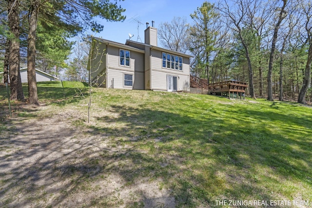 1087 Shore Walk Ln, Whitehall, MI 49461 - rear view of property with a chimney, a deck, and a yard