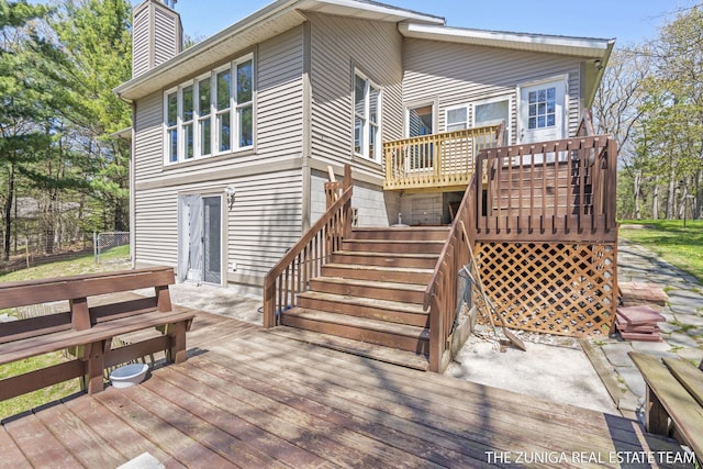 1087 Shore Walk Ln, Whitehall, MI 49461 - back of property featuring a deck, stairs, and a chimney