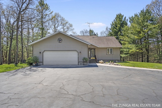 1087 Shore Walk Ln, Whitehall, MI 49461 - view of front facade with a garage, asphalt driveway, and roof with shingles