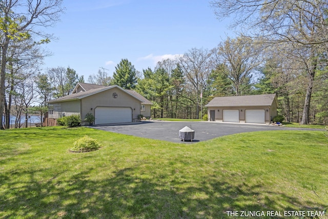 1087 Shore Walk Ln, Whitehall, MI 49461 - view of property exterior with a lawn and a garage