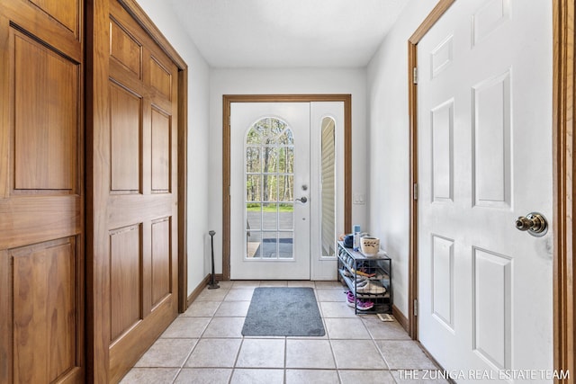 1087 Shore Walk Ln, Whitehall, MI 49461 - doorway to outside featuring baseboards and light tile patterned flooring