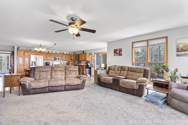 1087 Shore Walk Ln, Whitehall, MI 49461 - living room with ceiling fan, light colored carpet, a chandelier, and a textured ceiling