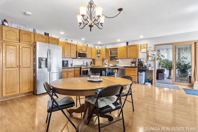 1087 Shore Walk Ln, Whitehall, MI 49461 - dining space with light wood finished floors, a chandelier, and recessed lighting