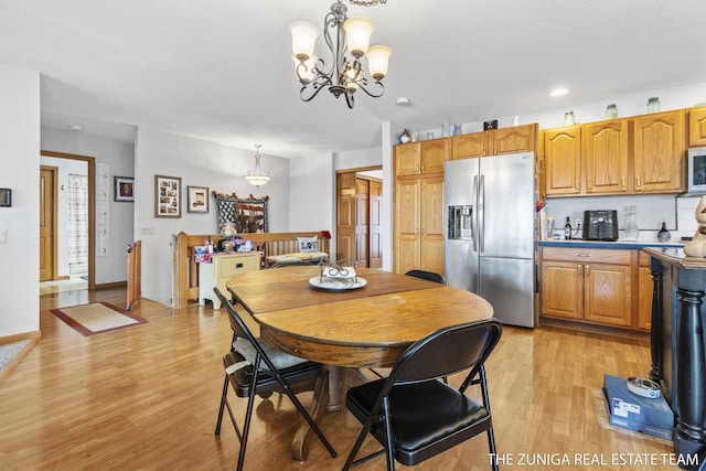 1087 Shore Walk Ln, Whitehall, MI 49461 - dining area featuring a chandelier, light wood-style flooring, and recessed lighting
