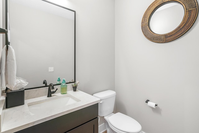 5414 Bradley Ct, Kalamazoo, MI 49009 - half bath featuring toilet, baseboards, and vanity