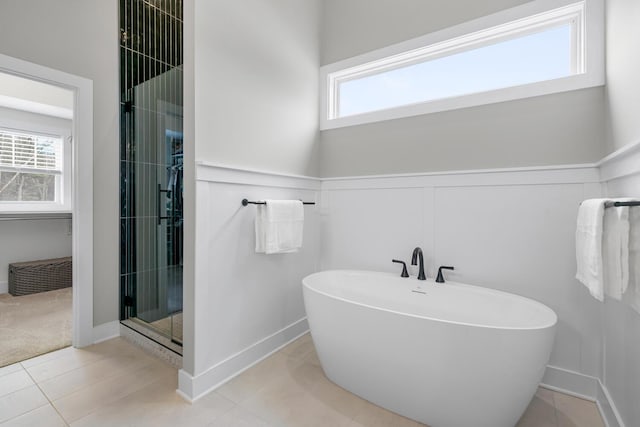 5414 Bradley Ct, Kalamazoo, MI 49009 - full bath with a stall shower, a freestanding bath, wainscoting, and tile patterned flooring