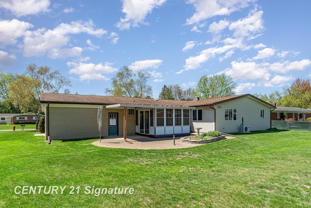 2936 Reppuhn Dr, Saginaw, MI 48603 - back of house with a sunroom, a lawn, and a patio
