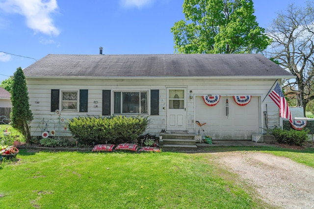 117 Hanover Ct, Hanover, MI 49241 - view of front of house featuring entry steps, driveway, an attached garage, a front lawn, and a shingled roof