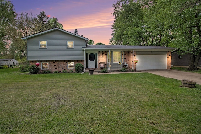 7055 N Center Rd, Mount Morris, MI 48458 - tri-level home featuring a garage, brick siding, concrete driveway, and a yard