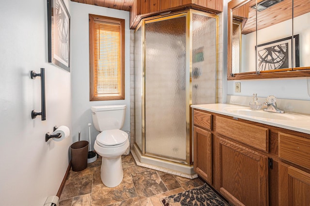2526 Aikens Rd, Manistee, MI 49660 - full bath with baseboards, toilet, a stall shower, stone finish flooring, and vanity