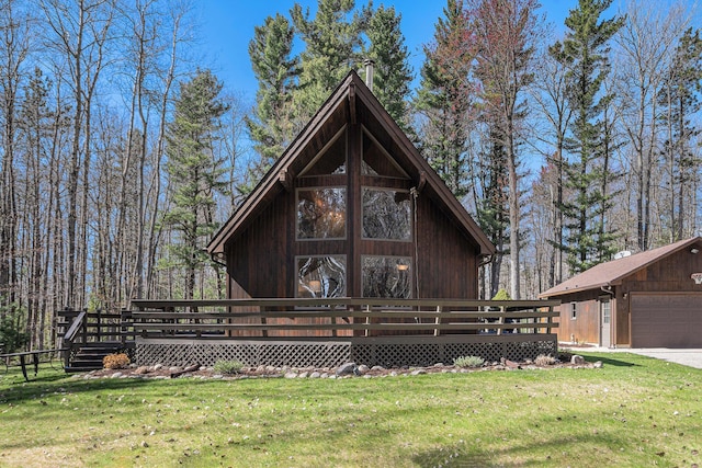 2526 Aikens Rd, Manistee, MI 49660 - back of house featuring a wooden deck and a lawn