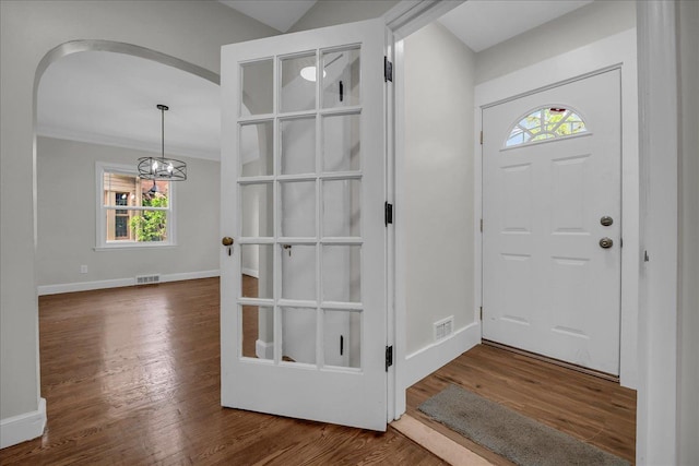 16585 Sunderland Rd, Detroit, MI 48219 - entrance foyer featuring arched walkways, plenty of natural light, and wood finished floors