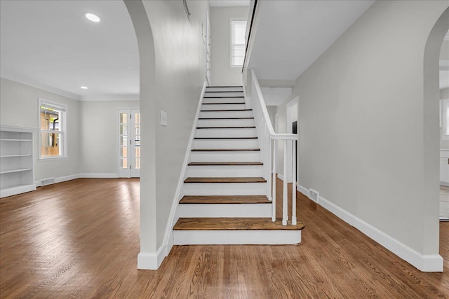 16585 Sunderland Rd, Detroit, MI 48219 - stairs with arched walkways, baseboards, wood finished floors, recessed lighting, and crown molding