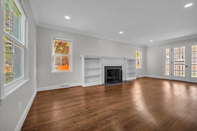 16585 Sunderland Rd, Detroit, MI 48219 - unfurnished living room with crown molding, a fireplace with flush hearth, baseboards, healthy amount of natural light, and dark wood-type flooring
