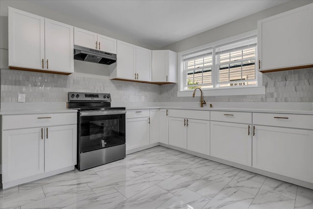 16585 Sunderland Rd, Detroit, MI 48219 - kitchen with stainless steel range with electric stovetop, light marble finish flooring, under cabinet range hood, and light countertops