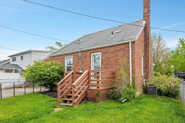 back of property with a shingled roof, brick siding, a wooden deck, cooling unit, and a chimney