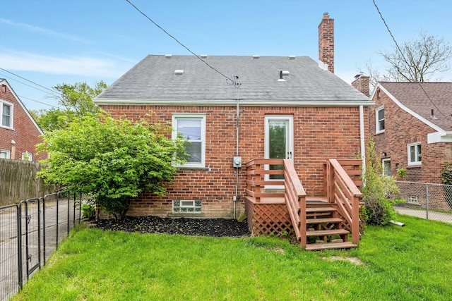 rear view of house with brick siding, a chimney, roof with shingles, and a wooden deck