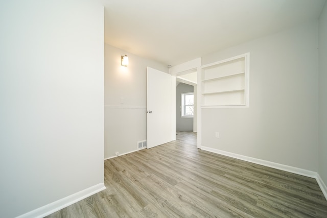 empty room with wood finished floors and baseboards