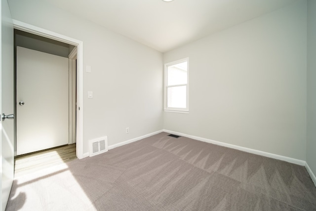 carpeted spare room with baseboards