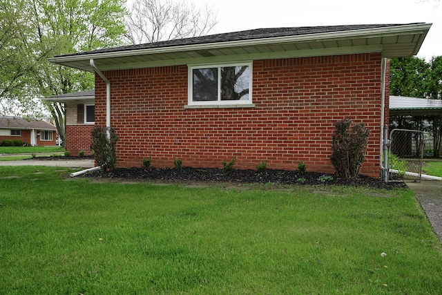 28407 Milton Ave, Warren, MI 48092 - view of side of property featuring brick siding, a lawn, and a carport