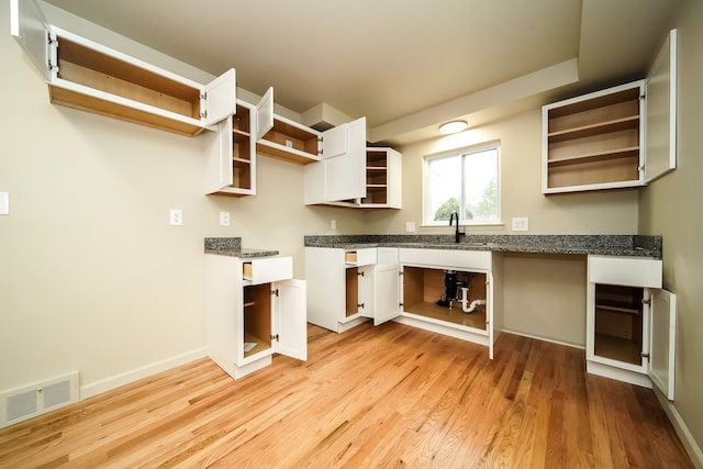 28407 Milton Ave, Warren, MI 48092 - kitchen with open shelves, light wood finished floors, white cabinetry, a sink, and baseboards