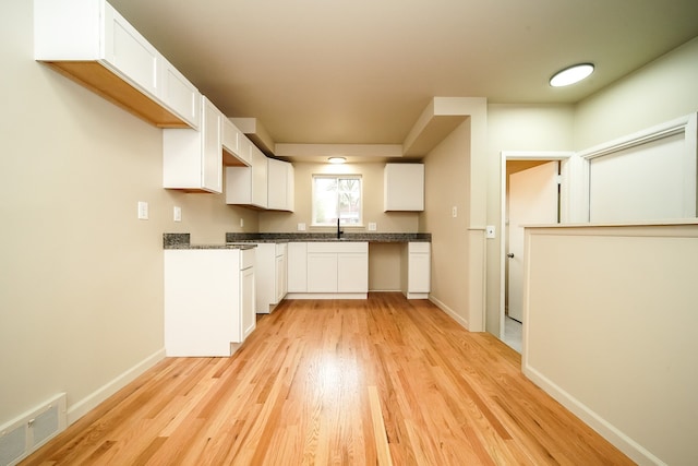 28407 Milton Ave, Warren, MI 48092 - kitchen with light wood finished floors, a sink, white cabinetry, and baseboards