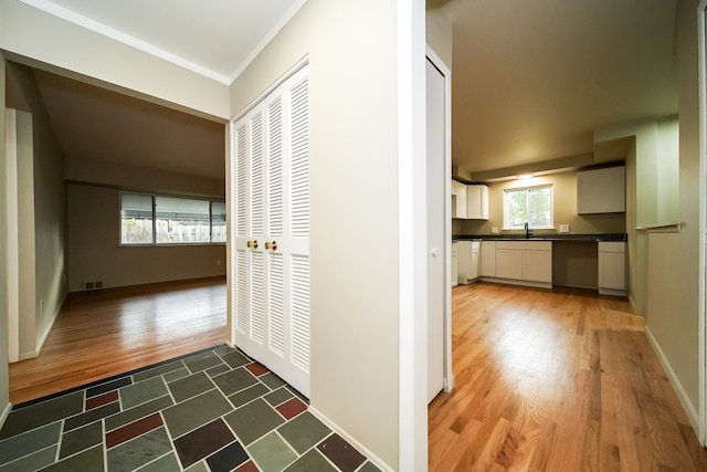 28407 Milton Ave, Warren, MI 48092 - hallway featuring wood finished floors, a sink, and baseboards