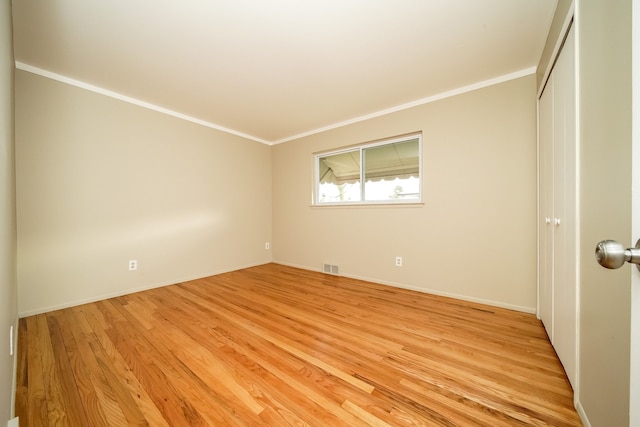 28407 Milton Ave, Warren, MI 48092 - spare room featuring crown molding, light wood-style floors, and baseboards