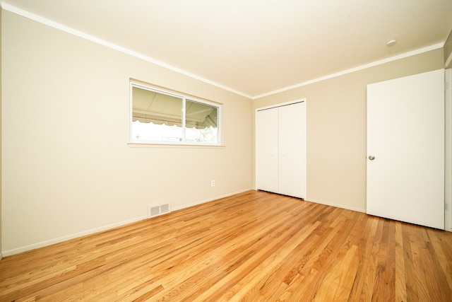 28407 Milton Ave, Warren, MI 48092 - unfurnished bedroom featuring ornamental molding, wood finished floors, a closet, and baseboards