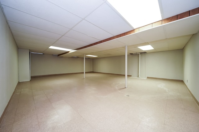 28407 Milton Ave, Warren, MI 48092 - finished below grade area featuring a paneled ceiling, baseboards, and tile patterned floors