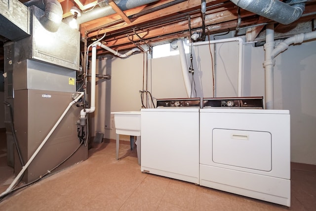 28407 Milton Ave, Warren, MI 48092 - laundry room featuring washing machine and dryer and heating unit