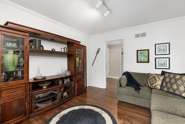 living room featuring dark wood-type flooring, ornamental molding, and baseboards