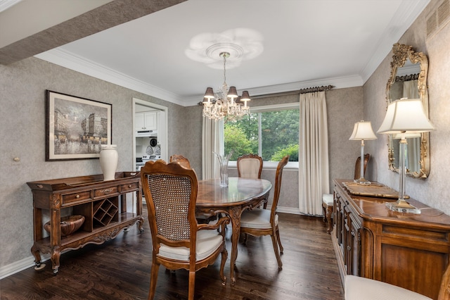 dining space featuring a chandelier, dark wood-style floors, crown molding, and baseboards