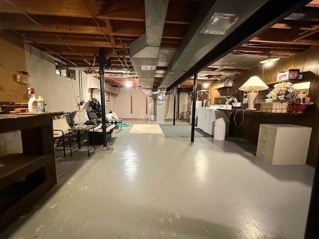 unfinished basement featuring washing machine and clothes dryer and heating unit