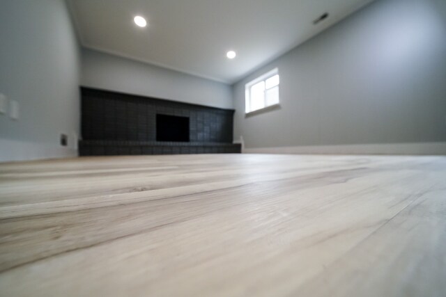 34067 Chatsworth Dr, Sterling Heights, MI 48312 - unfurnished living room featuring wood finished floors, a fireplace with raised hearth, recessed lighting, baseboards, and vaulted ceiling