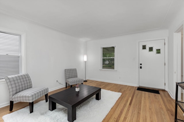 living area with light wood finished floors and baseboards