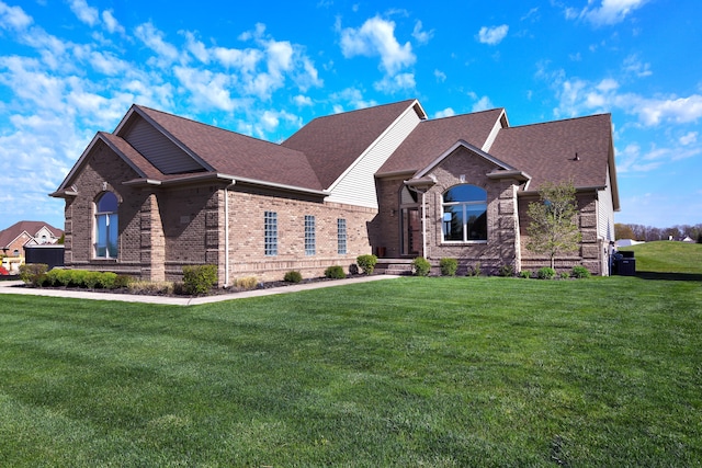 9185 Copper Ridge Dr, Davison, MI 48423 - view of front of house with brick siding, a front yard, and a shingled roof