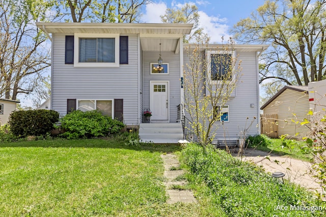 view of front of house with entry steps and a front lawn