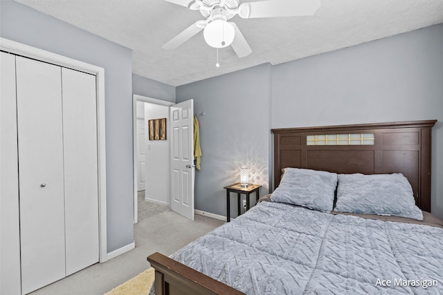 bedroom with carpet floors, baseboards, ceiling fan, and a closet