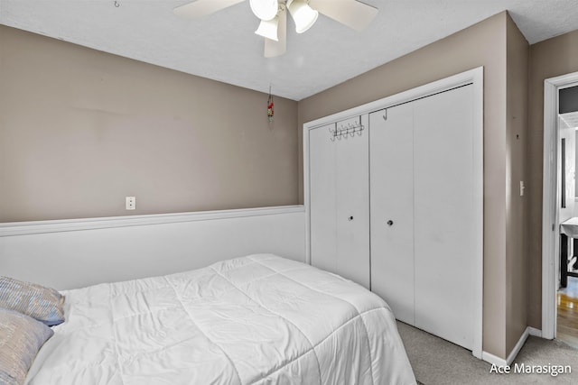 bedroom with carpet, a closet, baseboards, and a ceiling fan