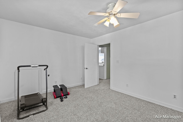 workout area with ceiling fan, baseboards, and carpet floors