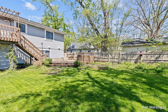 view of yard with a wooden deck and stairway