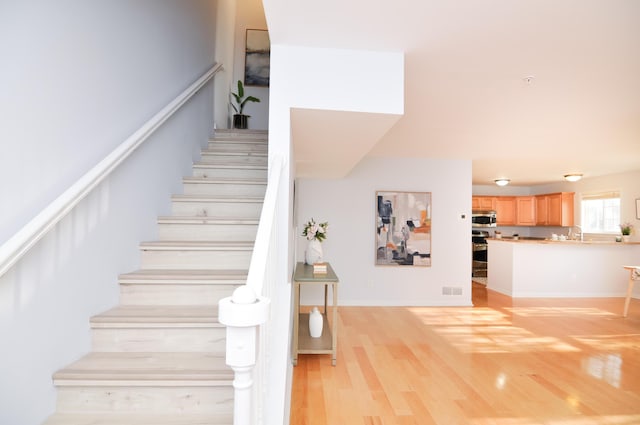 staircase with wood finished floors