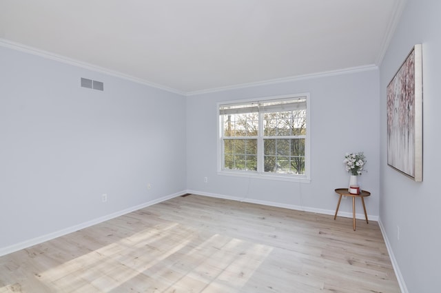 unfurnished room featuring ornamental molding, light wood-style flooring, and baseboards