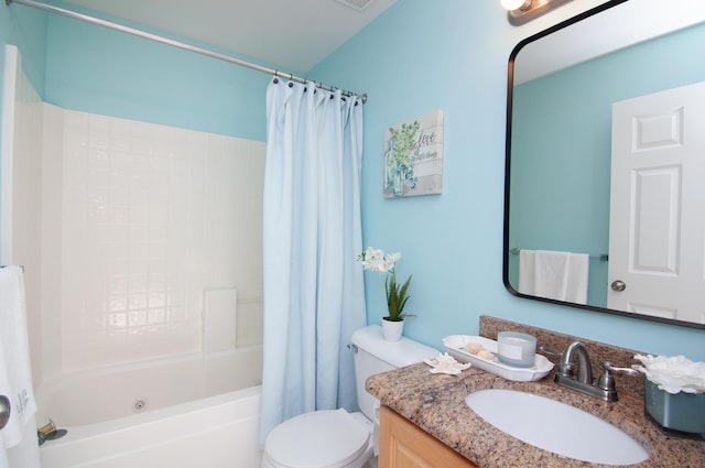 bathroom featuring toilet, vanity, and shower / bath combo with shower curtain