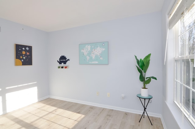 unfurnished room featuring light wood-type flooring and baseboards