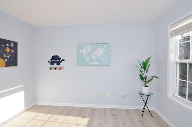 spare room featuring wood finished floors and baseboards